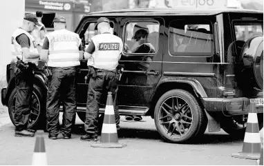  ?? AP FILE ?? Police officers control cars at a checkpoint near the Austrian and German border in Mittenwald, Germany, on Wednesday, June 22, 2022.