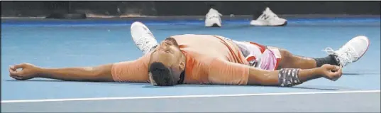  ?? Lee Jin-man The Associated Press ?? An exhausted Nick Kyrgios of Australia lies on the court Saturday as he celebrates after defeating Russia’s Karen Khachanov in a five-set, four-tiebreaker third-round Australian Open match in Melbourne. Up next is bitter rival Rafael Nadal.