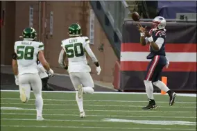  ?? CHARLES KRUPA - THE ASSOCIATED PRESS ?? New England Patriots quarterbac­k Cam Newton, right, catches a touchdown pass thrown by wide receiver Jakobi Meyers, as New York Jets defenders Bryce Hager, left, and Frankie Luvu give chase in the second half of an NFL football game, Sunday, Jan. 3, 2021, in Foxborough, Mass.