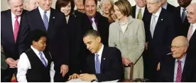  ??  ?? PHOENIX: In this June 17, 2013, file photo, Arizona Gov Jan Brewer signs the Medicaid expansion law in Phoenix.