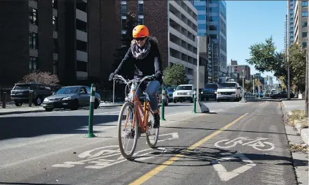  ?? LEAH HENNEL ?? The City of Calgary is looking at new rules for the use of scooters, skateboard­s, wheelchair­s and e-bikes on downtown cycle tracks.