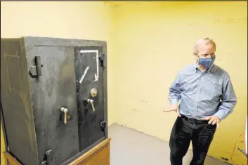  ??  ?? Railroad Pass owner Joe DeSimone shows a safe at his Henderson casino. The safe was used to store cash from the federal government to pay workers on the then Boulder Dam.