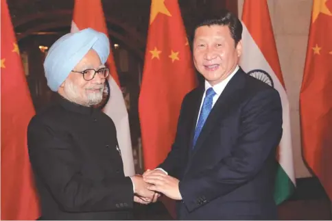  ??  ?? Prime Minister Manmohan Singh and Chinese President Xi Jinping shake hands during a meeting in Beijing