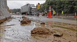  ?? CHUCK BURTON / ASSOCIATED PRESS ?? Workers block off lanes of Interstate 40 near Old Fort, N.C., on Wednesday after rain from the fringes of Subtropica­l Storm Alberto caused a mudslide Tuesday evening. The main east-west route through North Carolina was closed for hours.