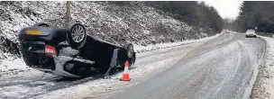  ??  ?? ●● A car landed on its roof after a crash on Grane Road