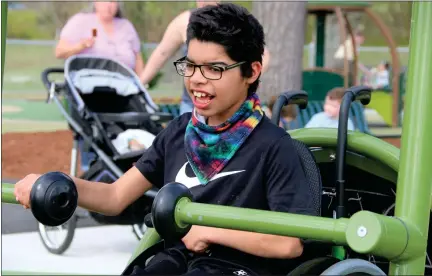  ?? DANIELLE RAY PHOTOS / SENTINEL & ENTERPRISE ?? Fitchburg resident Cameron Earley, 13, was all smiles playing on one of handicap accessible play structures at the Sam Pawlak Community Playground following the ribbon cutting on May 12.