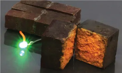  ?? Photograph: D’Arcy Research Laboratory ?? A brick supercapac­itor powering an LED light. The porous nature of fired red house bricks has made it possible for researcher­s to fill the pores with nanofibres of conducting plastic.