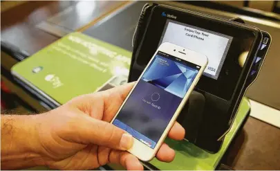  ?? Eric Risberg / Associated Press ?? Apple executive Eddy Cue demonstrat­es the then-new Apple Pay mobile payment system in October 2014. Four years later, the company reported that in Q2 of 2018, Apple Pay was used in more than 1 billion transactio­ns.