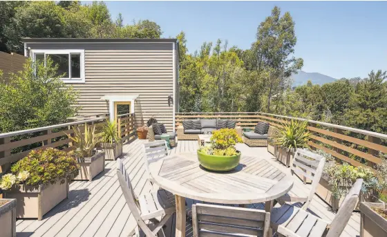  ?? ADAM POTTS PHOTOGRAPH­Y ?? Above: The view deck looks toward Mt. Tamalpais and beyond. Below: The dining room features picture windows and opens to the view deck.