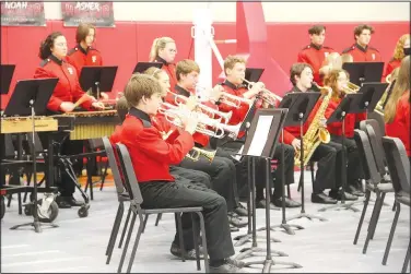  ?? (NWA Democrat-Gazette/Lynn Kutter) ?? Farmington High Band performed several songs Nov. 11 during the Farmington High School Veterans Day Assembly at Cardinal Arena. The band played Battle Hymn of the Republic and taps.