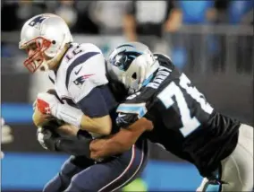  ?? MIKE MCCARN — THE ASSOCIATED PRESS FILE ?? In this file photo, New England Patriots’ Tom Brady (12) is sacked by Carolina Panthers’ Greg Hardy (76) during the first half of an NFL football game in Charlotte, N.C.