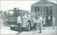  ?? SUBMITTED PHOTO ?? Above, Bob Eastburn, right, and Elvan Hedges (bending down) at the first Bryans Road Volunteer Fire Department building, working on Engine 111 in the 1960s. Below, Hedges, left, and Eastburn reenact the 1960s photo with Engine 111 nearly 60 years later.