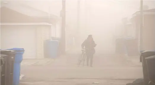  ?? TYLER PASCIAK LARIVIERE/SUN-TIMES FILES ?? A dust cloud covered the Little Village neighborho­od in April 2020 after the Crawford Coal Plant smoke stack was imploded.