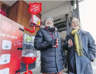  ?? DARREN STONE, TIMES COLONIST ?? Volunteers Nemad Laketic, left, and Sinisha Ivaz collect donations for the Salvation Army at Esquimalt Plaza.