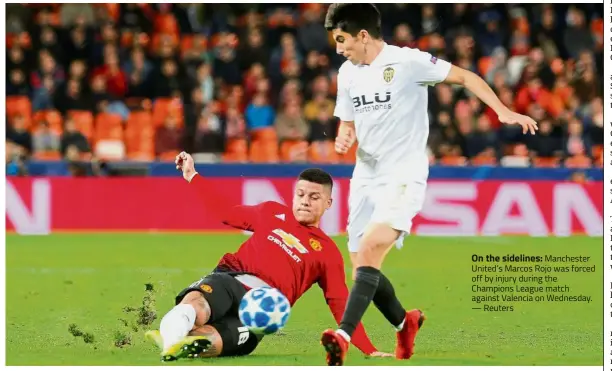  ?? — Reuters ?? On the sidelines: Manchester United’s Marcos Rojo was forced off by injury during the Champions League match against Valencia on Wednesday.