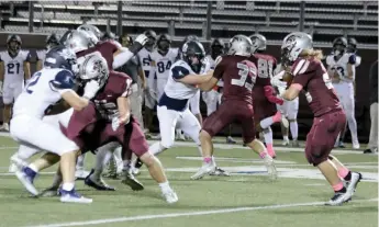  ?? Mark Ross/Special to The Herald-Leader ?? Siloam Springs running back Jed Derwin (right) looks for a hole on Friday, Oct. 14, against Little Rock Christian.