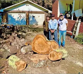  ?? C.C. Wilson III ?? Stephanie Bearden Moore, her father Bob Bearden and Brian Matlick stand in front of a heart shaped oak Matlick plans to craft as a table in memory of Bob’s late wife Opal.