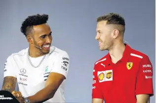  ?? PHOTO: REUTERS ?? What rivalry? Mercedes’ Lewis Hamilton (left) and Ferrari’s Sebastian Vettel share a joke during an Australian Grand Prix press conference in Melbourne this week.