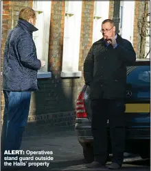  ??  ?? ALERT: Operatives stand guard outside the Halls’ property