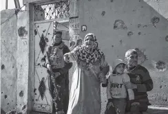  ??  ?? A woman shouts at Iraqi security forces after a family member was arrested in the eastern part of Mosul. Security forces searched the liberated part of the city for suspected Islamic State group members still living in the town.