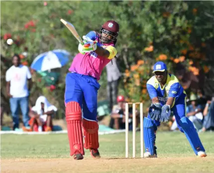  ?? (Photo: Garfield Robinson) ?? Former West Indies batsman Chris Gayle (left) strikes the ball as wicketkeep­er Shane Ford reacts during the Legends T20 cricket festival at Treasure Beach Sports Park in St Elizabeth on Sunday, January 15, 2023.