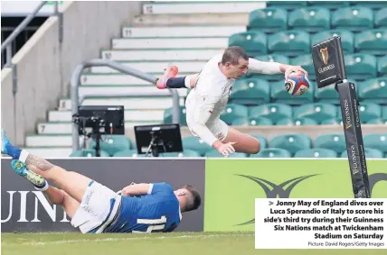  ?? Picture: David Rogers/Getty Images ?? Jonny May of England dives over Luca Sperandio of Italy to score his side’s third try during their Guinness Six Nations match at Twickenham
Stadium on Saturday