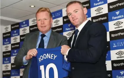  ??  ?? LIVERPOOL: This file photo taken on July 10, 2017 shows Everton’s new signing, English striker Wayne Rooney (R) poses for a photograph with his new club shirt, held by Everton’s Dutch manager Ronald Koeman (L) during a press conference at Goodison Park...
