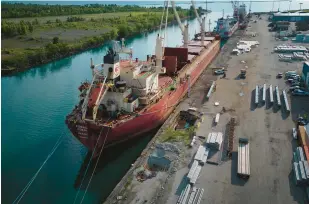  ?? E. JASON WAMBSGANS/CHICAGO TRIBUNE ?? Holes can be seen in the dilapidate­d surface of the dock near freighters at the Illinois Internatio­nal Port District facility on the Calumet River at Lake Michigan in Chicago on July 18.