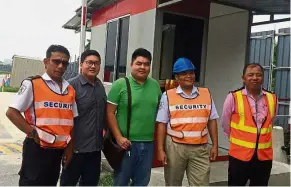  ??  ?? New job: Johan (second from right) at a constructi­on site in Kuala Lumpur with (from left) security supervisor Aharulazal­i Mohd Hanipah, operation managers Eric Tan and Eric Chan, and security supervisor Simon Lim.
