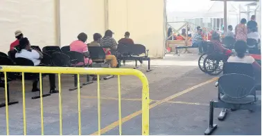  ?? PHOTO BY CHRISTOPHE­R THOMAS ?? Patients sitting in the vicinity of the Accident and Emergency Department at the Cornwall Regional Hospital in St James.