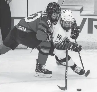  ?? LIAM RICHARDS/THE CANADIAN PRESS ?? Canada forward Blayre Turnbull and United States forward Brianna Decker battle for the puck during the first period of a 4 Nations Cup preliminar­y game in Saskatoon on Wednesday.