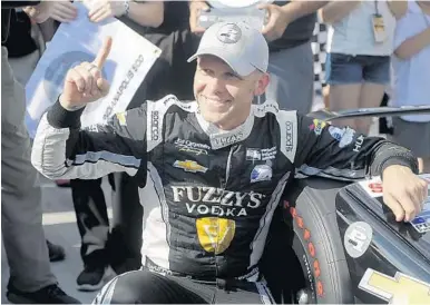  ?? MICHAEL CONROY/AP ?? Ed Carpenter celebrates after winning the Indy 500 pole for the third time. He kept the Penske team from having the entire front row. His teammate, Danica Patrick, qualified seventh for her final race.