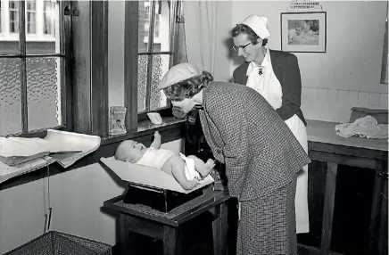  ??  ?? Taken in 1957, featuring little John Patrick Kelliher, only son of Mr and Mrs P Kelliher being weighed. The laughing 19-week-old boy is being watched by his mother and Plunket nurse, Miss MC Smart.