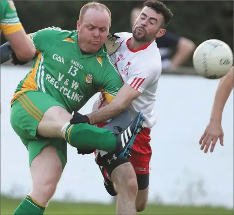  ??  ?? Johnny Lynch does enough to score a point for Westerns as Aaron Kane attempts a block for John Mitchels.