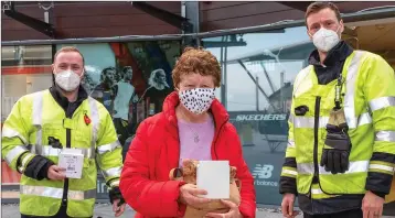  ??  ?? Breda Hobbs, with her free smoke alarm, with firemen Stephen Wade (left) and Joshua Barrington.