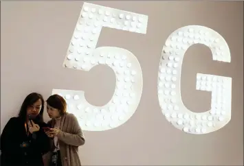  ?? RAFAEL MARCHANTE Reuters ?? A 5G LED Smart Bulb panel shines brightly inside the Xiaomi booth at the Mobile World Congress in Barcelona in February. Somewhere in the future South Africa will experience the much faster world of 5G, says the writer. I