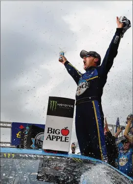  ?? JARED C. TILTON / GETTY IMAGES ?? Kevin Harvick exults in victory lane Sunday at the New Hampshire Speedway in Loudoun, N.H., after his win in a NASCAR Cup race.