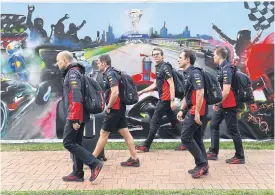  ??  ?? Red Bull team members leave the Australian Grand Prix site on Friday.