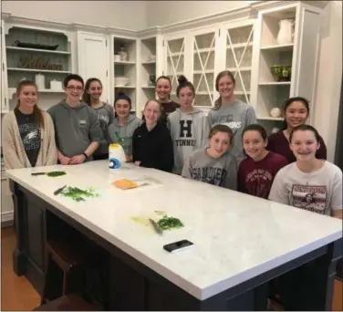  ?? SUBMITTED PHOTO ?? Henderson High School students prepare meals for Safe Harbor of Chester County. The students are members of a service club at Henderson called Kids “4” Kids and gathered at The Kitchen Studio at Pine Street in West Goshen on Sunday for an afternoon of cooking and service.