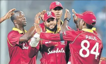  ?? AFP ?? (From left) West Indies paceman Kemar Roach, wicketkeep­erbatsman Shai Hope, Kieran Powell and Keemo Paul celebrate the fall of an Indian wicket during their upset win in the third ODI at the MCA Stadium in Pune on Saturday.
