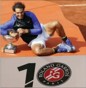  ?? PETR DAVID JOSEK — THE ASSOCIATED PRESS ?? The logo on the podium was altered to read “10” for Spain’s Rafael Nadal tenth French Open title against Switzerlan­d’s Stan Wawrinka in three sets, 6-2, 6-3, 6-1, during their men’s final match of the French Open tennis tournament at the Roland Garros...