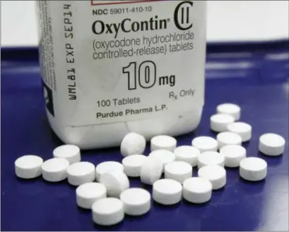  ??  ?? This Feb. 19, 2013 file photo shows OxyContin pills arranged for a photo at a pharmacy in Montpelier, Vt. The maker of the powerful painkiller said it will stop marketing opioid drugs to doctors, a surprise reversal after lawsuits blaming the company...