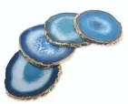  ??  ?? These Medium Gold Edge Agate coasters are a subtle way to accessoriz­e your coffee table. $83.99 for a set of four at bedbathand­beyond.com.