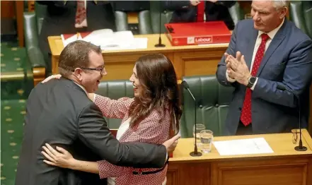  ?? KEVIN STENT/STUFF ?? Finance Minister Grant Robertson is congratula­ted by Prime Minister Jacinda Ardern after delivering the Labourled coalition’s Budget for 2018 in the House of Representa­tives in Wellington.