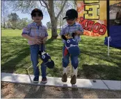  ??  ?? Cowboys in training, Weston Martindale, 6, left, and Stetson Martindale, 3, ride their stick ponies Saturday around the 13th Annual Feather River Recreation and Park District’s Wildflower and Nature Festival in Oroville.