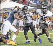  ?? Bambara Aven, @avenphoto ?? Ridgeland’s Jeremiah Turner looks for room to run during Friday’s game against Troup in LaGrange. The Panthers will take this Friday night off and will play their first home game of the season next week against Sandy Creek.