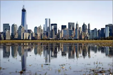  ?? MEL EVANS — THE ASSOCIATED PRESS FILE ?? New York’s Lower Manhattan skyline, including the One World Trade Center, left, is reflected in water on April 6, 2013, as seen from Liberty State Park in Jersey City, N.J. Eight of the 10largest cities in the U.S. lost population during the first year of the pandemic, with only Phoenix and San Antonio gaining new residents from 2020 to 2021, according to new estimates released, May 26by the U.S. Census Bureau.