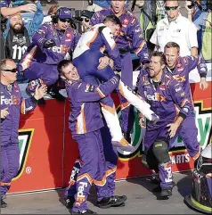  ?? MATT SULLIVAN / GETTY IMAGES ?? Denny Hamlin gets a lift from his crew after winning in Avondale, Arizona, and earning a chance to win the season title next week. Facing eliminatio­n entering the race, Hamlin pulled into the lead on a restart and cruised to his sixth victory of the season.