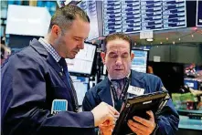  ?? [AP PHOTO] ?? Executive Floor Gov. Charles Caccese, left, and trader Tommy Kalikas on Friday consult on the floor of the New York Stock Exchange.