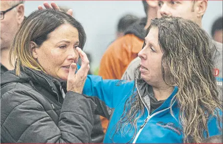  ?? RICK MADONIK/ TORONTO STAR ?? Jenn Cowie comforts Lianna Hall as GM workers gather at Unifor Local 222 offices in Oshawa on Monday after the automaker announced plans to shutter its plant in the city.